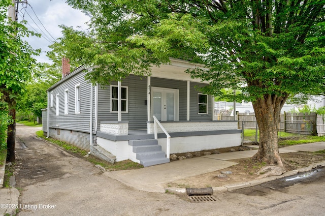 474 N 29th St, Louisville, KY 40212 - view of front facade with a porch, fence, a chimney, and french doors
