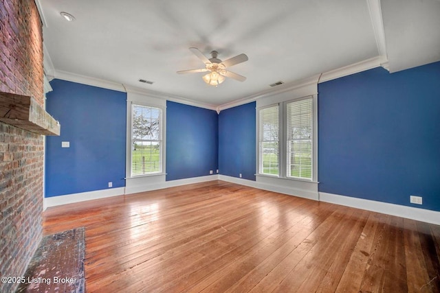 unfurnished living room with ceiling fan, crown molding, hardwood / wood-style floors, and baseboards