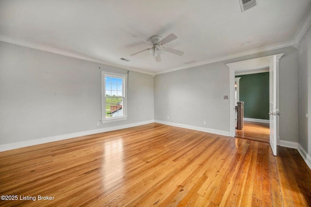 empty room with a ceiling fan, light wood-type flooring, baseboards, and ornamental molding