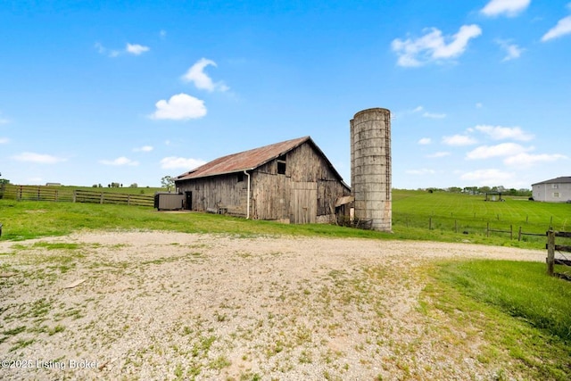 view of barn featuring a rural view