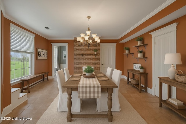 dining space with light tile patterned floors, a chandelier, ornamental molding, and baseboards