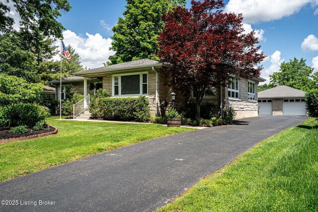 8703 Waltlee Rd, Louisville, KY 40291 - view of front of home featuring stone siding, a detached garage, a front yard, and an outdoor structure