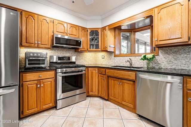 8703 Waltlee Rd, Louisville, KY 40291 - kitchen with stainless steel appliances, a sink, crown molding, light tile patterned flooring, and brown cabinetry
