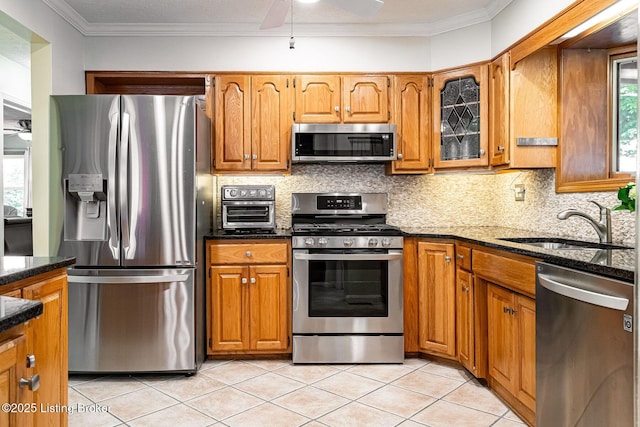 8703 Waltlee Rd, Louisville, KY 40291 - kitchen featuring stainless steel appliances, ceiling fan, brown cabinetry, and ornamental molding