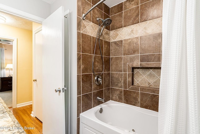 8703 Waltlee Rd, Louisville, KY 40291 - bathroom with wood finished floors, shower / bathtub combination with curtain, and baseboards