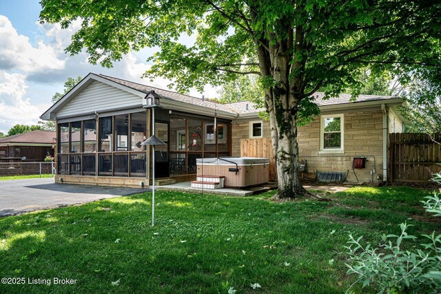 8703 Waltlee Rd, Louisville, KY 40291 - back of house featuring a hot tub, a sunroom, stone siding, and a patio