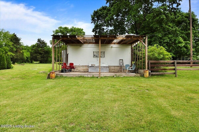 rear view of property featuring a patio area and a pergola