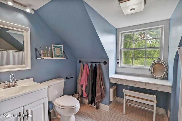 full bath featuring vanity, lofted ceiling, toilet, and baseboards