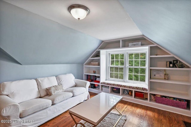 living room with wood finished floors and vaulted ceiling
