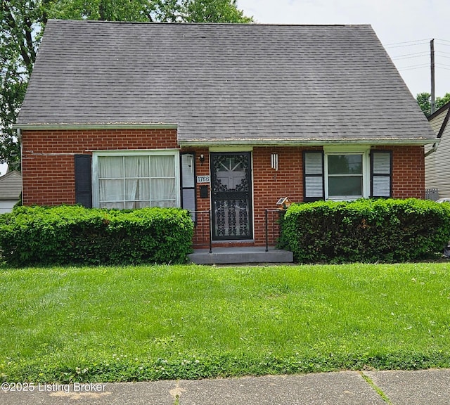 1766 Wilart Dr, Louisville, KY 40210 - view of front of house with brick siding, a front yard, and a shingled roof