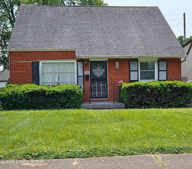 1766 Wilart Dr, Louisville, KY 40210 - view of front of house featuring brick siding, a front yard, and roof with shingles