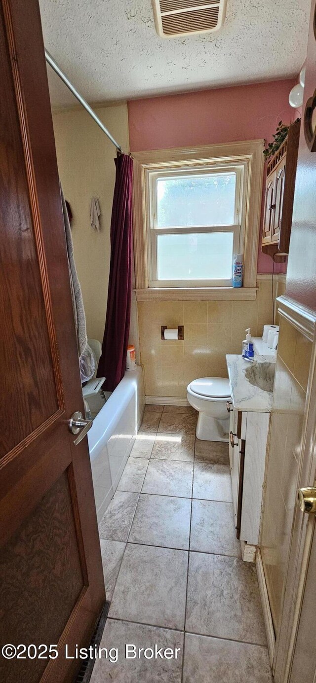1766 Wilart Dr, Louisville, KY 40210 - bathroom with a textured ceiling, tile patterned flooring, toilet, shower / bath combination with curtain, and vanity