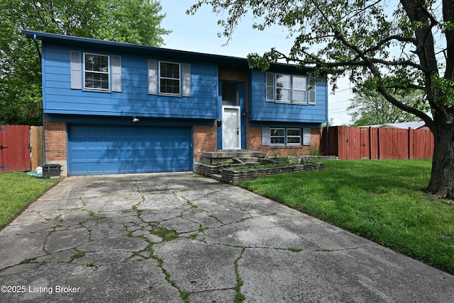 4433 Malcolm Rd, Louisville, KY 40216 - split foyer home with brick siding, a garage, and driveway
