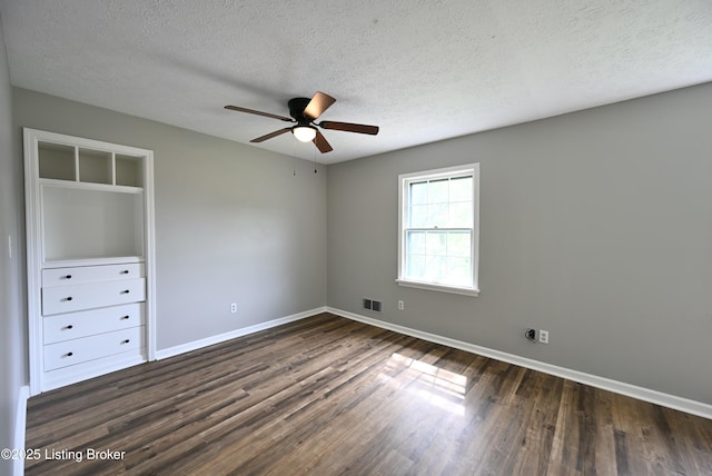 4433 Malcolm Rd, Louisville, KY 40216 - unfurnished bedroom featuring dark wood-type flooring, baseboards, a textured ceiling, and ceiling fan