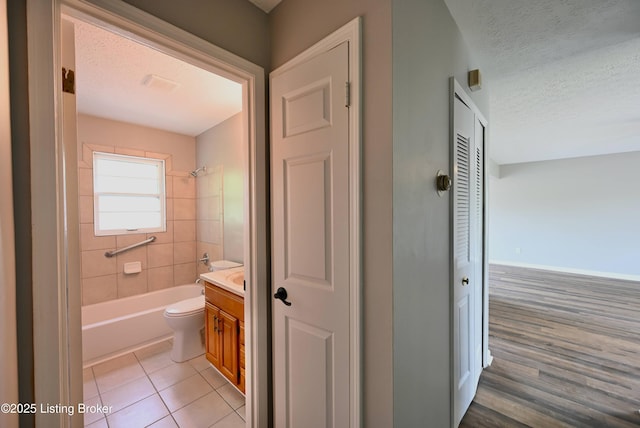 4433 Malcolm Rd, Louisville, KY 40216 - bathroom with vanity, toilet, a textured ceiling, shower / washtub combination, and tile patterned floors