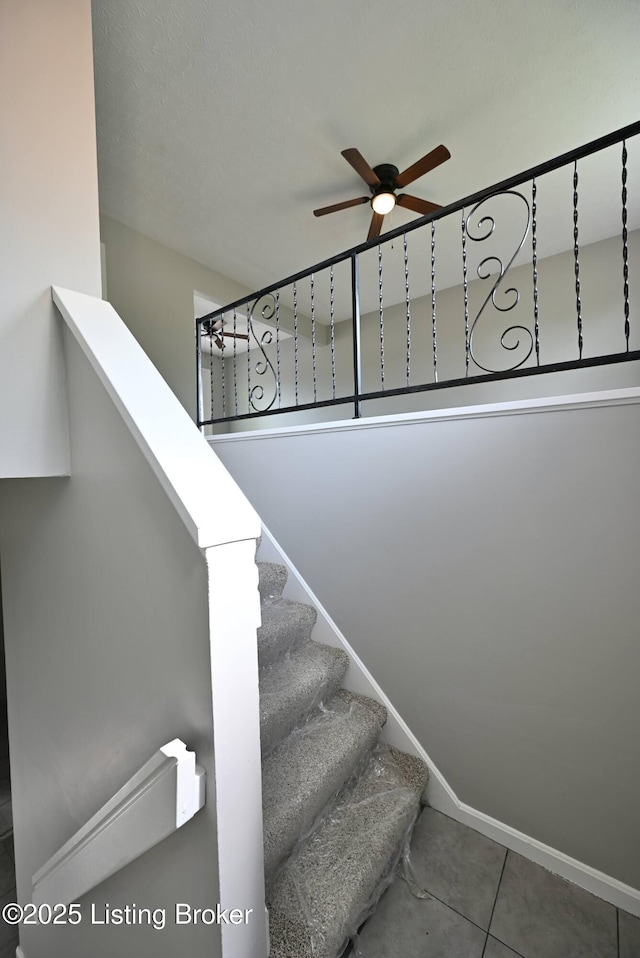 4433 Malcolm Rd, Louisville, KY 40216 - stairs featuring a ceiling fan and tile patterned flooring
