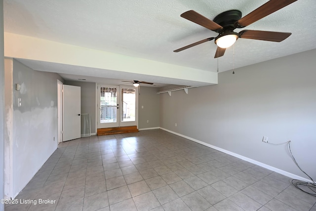 4433 Malcolm Rd, Louisville, KY 40216 - empty room featuring light tile patterned flooring, ceiling fan, baseboards, and a textured ceiling