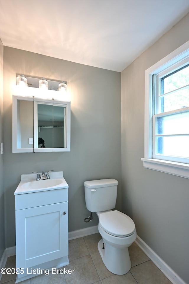 4433 Malcolm Rd, Louisville, KY 40216 - bathroom with toilet, tile patterned floors, baseboards, and vanity