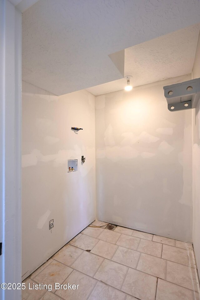4433 Malcolm Rd, Louisville, KY 40216 - laundry room featuring hookup for a washing machine and a textured ceiling