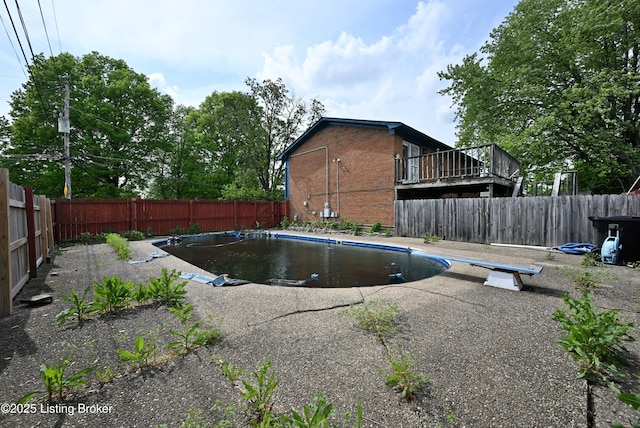 4433 Malcolm Rd, Louisville, KY 40216 - view of swimming pool with a diving board and a fenced backyard