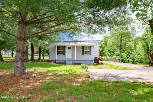 bungalow with a porch and metal roof