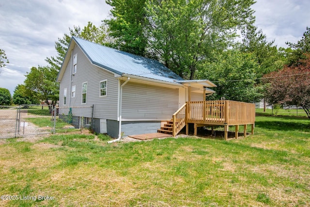 rear view of property with a gate, a wooden deck, metal roof, and stairs