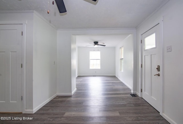 foyer entrance with ceiling fan, wood finished floors, baseboards, and ornamental molding