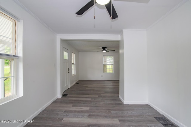 spare room featuring a ceiling fan, wood finished floors, ornamental molding, and baseboards