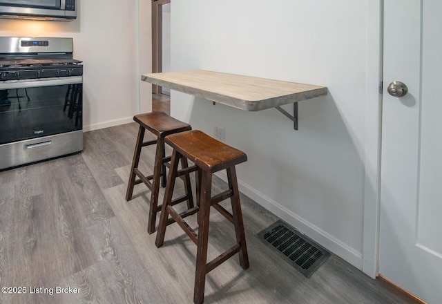 dining room with wood finished floors and baseboards