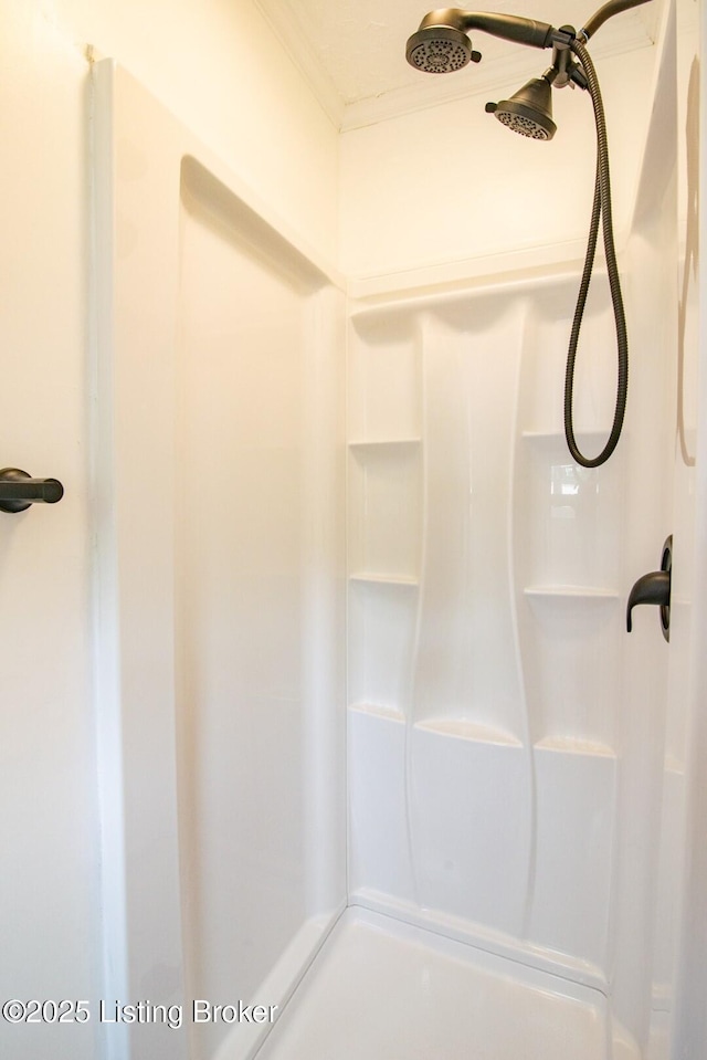 full bath with a shower and ornamental molding