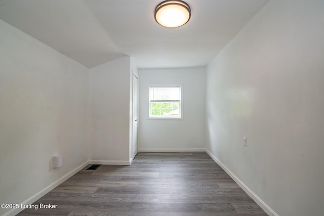 empty room with wood finished floors and baseboards