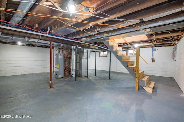 basement with gas water heater and stairway