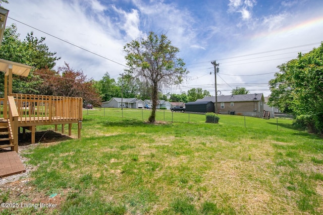 view of yard with a wooden deck and stairway