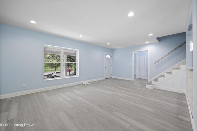 5319 New Cut Rd, Louisville, KY 40214 - unfurnished living room featuring recessed lighting, wood finished floors, stairs, and baseboards