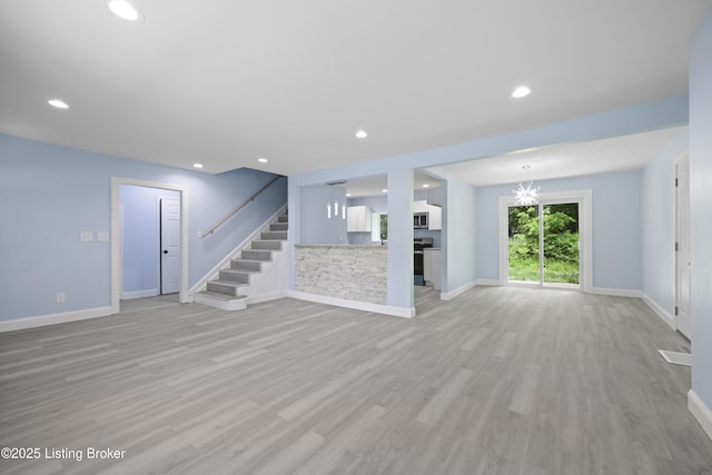 5319 New Cut Rd, Louisville, KY 40214 - unfurnished living room featuring stairway, light wood finished floors, baseboards, and recessed lighting