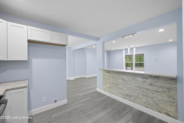 5319 New Cut Rd, Louisville, KY 40214 - kitchen featuring white cabinets, wood finished floors, baseboards, and recessed lighting