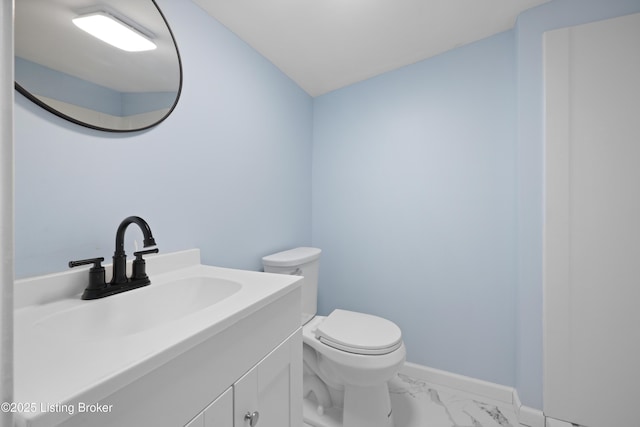 5319 New Cut Rd, Louisville, KY 40214 - bathroom featuring marble finish floors, vanity, toilet, and baseboards