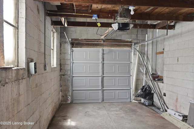 5319 New Cut Rd, Louisville, KY 40214 - garage featuring concrete block wall and a garage door opener