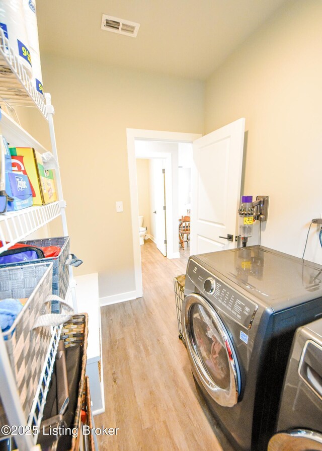 9206 Fox Chase Rd, Louisville, KY 40228 - laundry room with separate washer and dryer, light wood finished floors, and baseboards