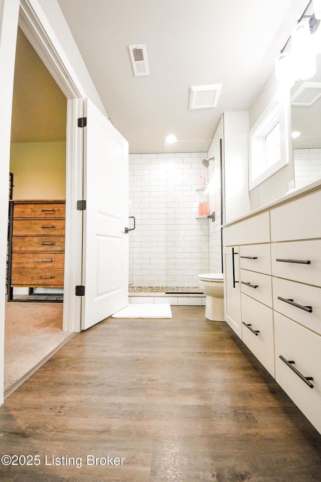 9206 Fox Chase Rd, Louisville, KY 40228 - full bathroom featuring a stall shower, toilet, vanity, and wood finished floors