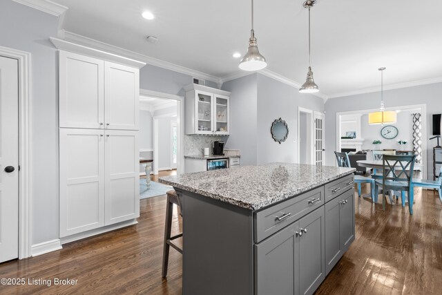 4026 Old Farm Dr, Crestwood, KY 40014 - kitchen featuring dark wood-style flooring, gray cabinetry, white cabinetry, decorative light fixtures, and crown molding