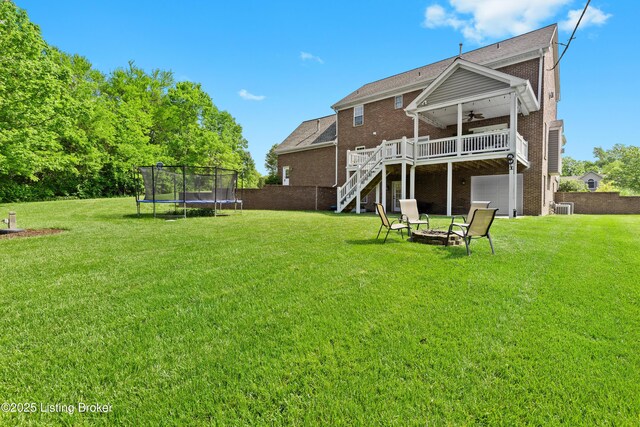 4026 Old Farm Dr, Crestwood, KY 40014 - back of house featuring a ceiling fan, brick siding, a trampoline, stairway, and a wooden deck