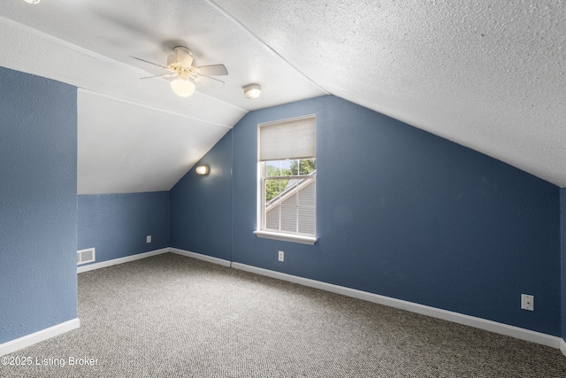 267 Stellar Dr, Shepherdsville, KY 40165 - additional living space with carpet floors, vaulted ceiling, a ceiling fan, baseboards, and a textured ceiling