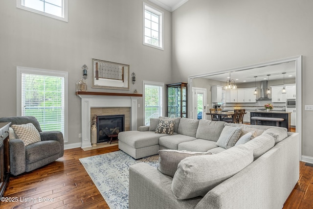 13412 Hampton Cir, Goshen, KY 40026 - living area featuring a towering ceiling, dark wood-type flooring, healthy amount of natural light, a fireplace with flush hearth, and baseboards