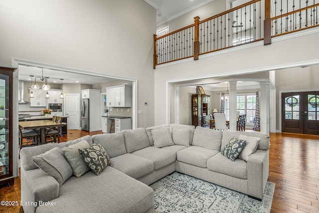 13412 Hampton Cir, Goshen, KY 40026 - living area featuring a towering ceiling, decorative columns, crown molding, and dark wood-style floors