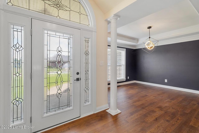 entrance foyer with decorative columns, dark wood-style floors, baseboards, and ornamental molding