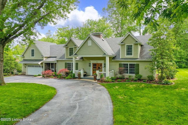 801 Shady Ln, Anchorage, KY 40223 - view of front facade featuring driveway, a front lawn, roof with shingles, a chimney, and an attached garage