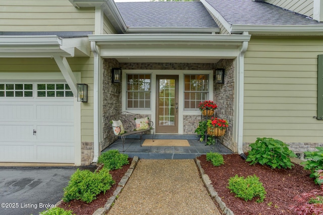 801 Shady Ln, Anchorage, KY 40223 - doorway to property with stone siding, roof with shingles, covered porch, and an attached garage