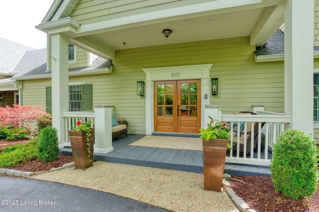801 Shady Ln, Anchorage, KY 40223 - property entrance featuring a shingled roof, french doors, and covered porch