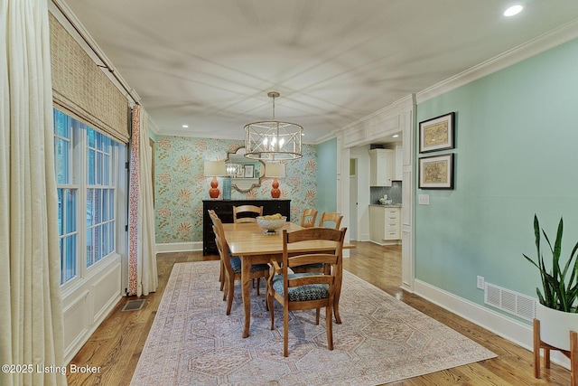 801 Shady Ln, Anchorage, KY 40223 - dining space featuring crown molding, a chandelier, wood finished floors, and baseboards